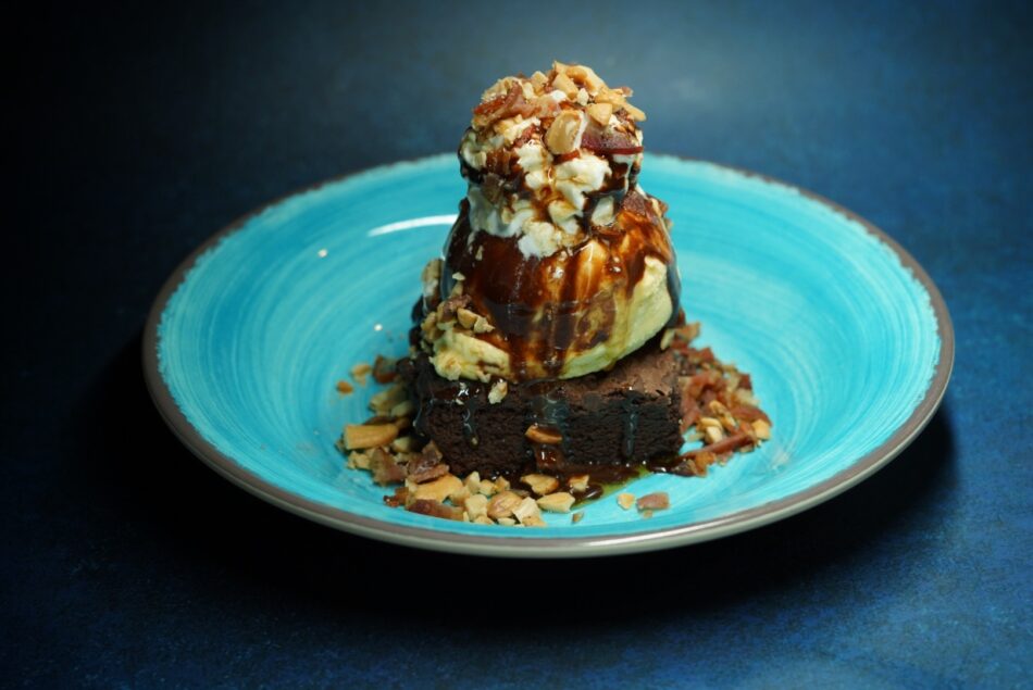 Bacon brownie with ice cream on a turquoise plate